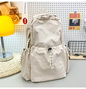 Solid color nylon casual backpack with drawstring and large capacity for daily school and travel use.