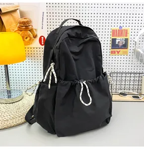 Solid color nylon casual backpack for women, large capacity school bag for daily travel.