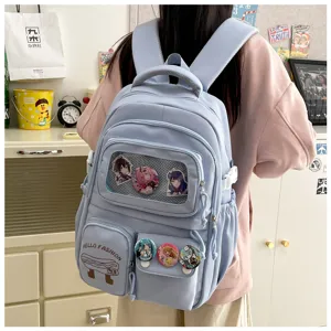 Japanese style light blue student backpack with transparent pocket and anime badges.