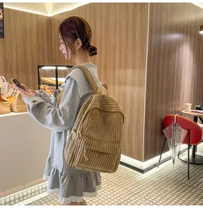 Detailed view of casual corduroy backpack worn in lifestyle scene, soft texture and practical.
