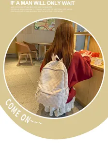 Casual checkered canvas backpack for women, large capacity daily school bag for students.