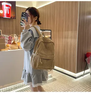 Solid color corduroy backpack for women, casual daily school bag and versatile travel daypack.