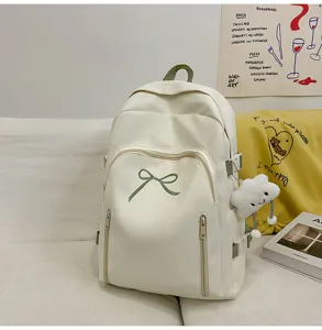 Detail view of the cute Japanese style white student backpack featuring a sweet green bow detail.