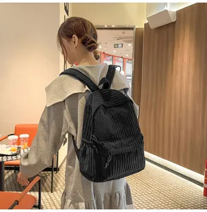 Classic black corduroy backpack for women, versatile school bag for daily casual use.