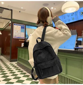 Solid color corduroy backpack detail view, featuring soft textured fabric and casual style.