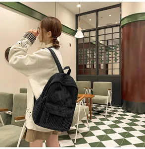 Casual black corduroy backpack for women, stylish everyday school bag and college daypack.