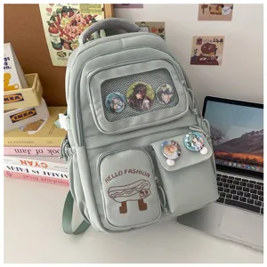 Detailed view of light green student backpack with cute badges, transparent mesh pocket and graphic.