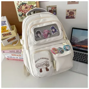 Cute Japanese style white canvas backpack with large capacity and anime badge decor.