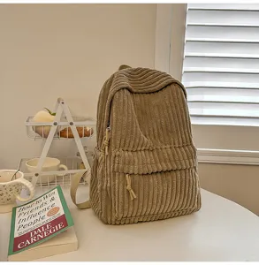 Corduroy backpack detail view, casual style, beige color, soft fabric texture lifestyle shot.