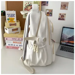 Detail view of the minimalist white casual backpack, showcasing side pocket and durable straps.