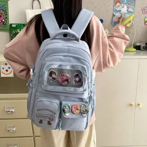 Cute Japanese style blue student backpack with transparent pocket and anime badges, large capacity.