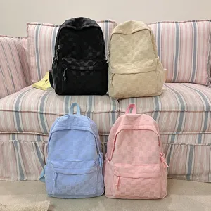 Cute checkered plush backpack for women, stylish large capacity school bag for daily use.