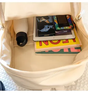 Interior detail of minimalist solid color canvas school backpack with large capacity.