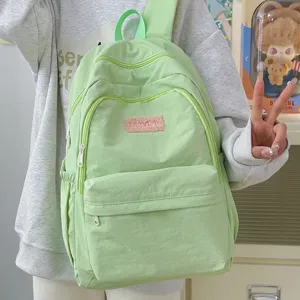Lightweight casual backpack for women, fresh green school bag with multiple zipper pockets.
