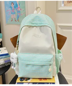 Green white grid school backpack detail view featuring cute plush cloud pendant and logo.