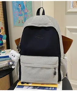 Japanese style plaid backpack for students, large capacity casual travel school bag in black and white.
