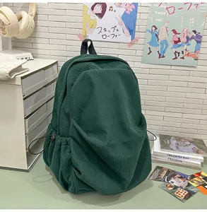 Green corduroy backpack for women, casual vintage college school bag with side drawstring pockets.