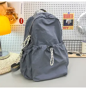 Detail view of solid nylon backpack, showing large capacity drawstring pocket and structure.