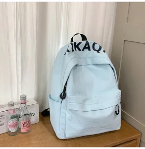 Casual light blue backpack for women, stylish Korean style school book bag with letters.