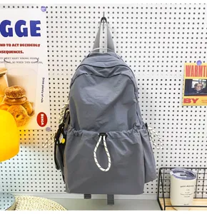 Solid color nylon backpack for women, large capacity travel school bag for students casual daily use.