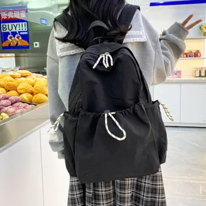 Solid color nylon backpack for women, large capacity school bag and lightweight travel daypack.