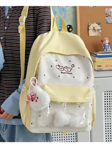 Detail view of the cute yellow polka dot backpack with clear pocket and plush charm showcase.