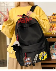 Large capacity black canvas backpack with stylish patches, casual school bag for daily use.