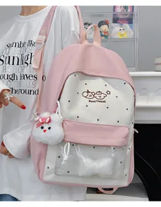 Pink canvas school backpack with clear front pocket, cute polka dot pattern and charms.