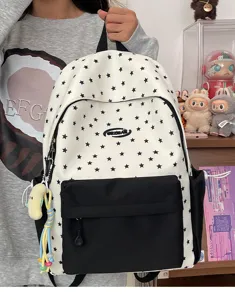 Detailed shot of the trendy star pattern school backpack, showing front pocket and pendant.