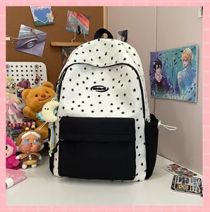 Trendy black and white star print backpack with front pocket and cute moon pendant for daily use.
