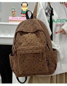 Brown corduroy backpack with cute heart bow print, featuring front pocket and side slots for daily.