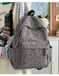 Casual gray corduroy backpack for women, cute bow and heart print school bag for daily use.