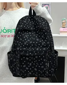 Black corduroy backpack with cute bows and hearts pattern for daily travel and school use.