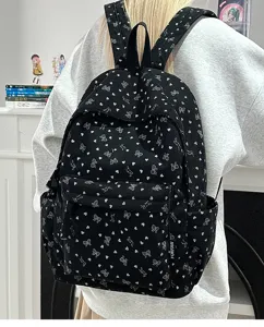 Black corduroy backpack with cute white heart and bow print, casual daily travel school bag.