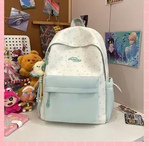 Detailed view of the cute star patterned school backpack with front pocket and hanging pendant.