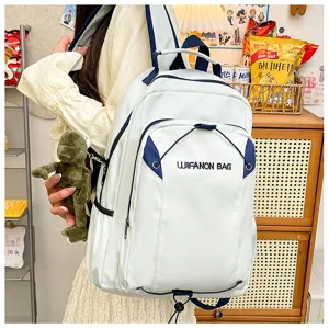 Detailed view of the casual student backpack showcasing white fabric, navy trim, and frog pendant.