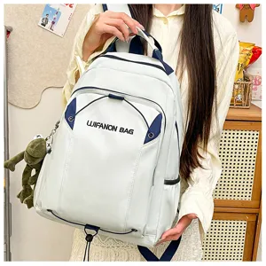 Lightweight waterproof school backpack for women, large capacity travel daily use casual daypack with cute doll pendant.
