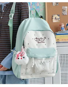 Cute pastel green polka dot school backpack with transparent front pocket and bunny pendant.