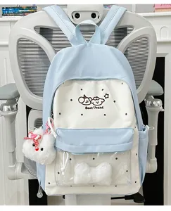 Detailed view of cute pastel blue polka dot backpack with front clear window and plush decor.