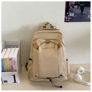 Detailed view of casual beige water-resistant backpack, large capacity school bag.
