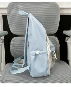 Light blue canvas student backpack with clear front pocket detail side profile view