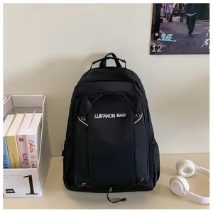 Black backpack detail view showing the front pocket design and durable material structure