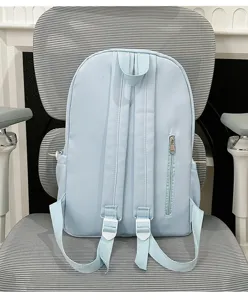 Light blue casual school backpack with adjustable straps and zipper pocket details for daily use.