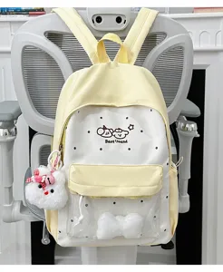 Cute pastel yellow and white student backpack with clear ita window and plush pendant for daily use.