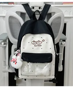 Cute black white polka dot canvas backpack with clear front pocket and kawaii plush pendant.