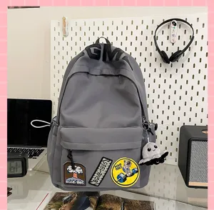 Grey casual school backpack large capacity student bookbag with cute patches and octopus pendant.