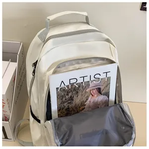 Detailed view of the large capacity white backpack front pocket, showing spacious interior design.