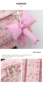 Sweet pink corduroy backpack for women, stylish bow pendant and cute heart print school bag.