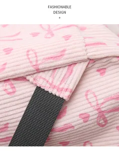 Pink corduroy bow backpack detail close-up showing soft textured fabric and black strap.