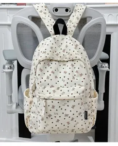 Corduroy backpack for women, casual school bookbag with cute bows and hearts pattern design.